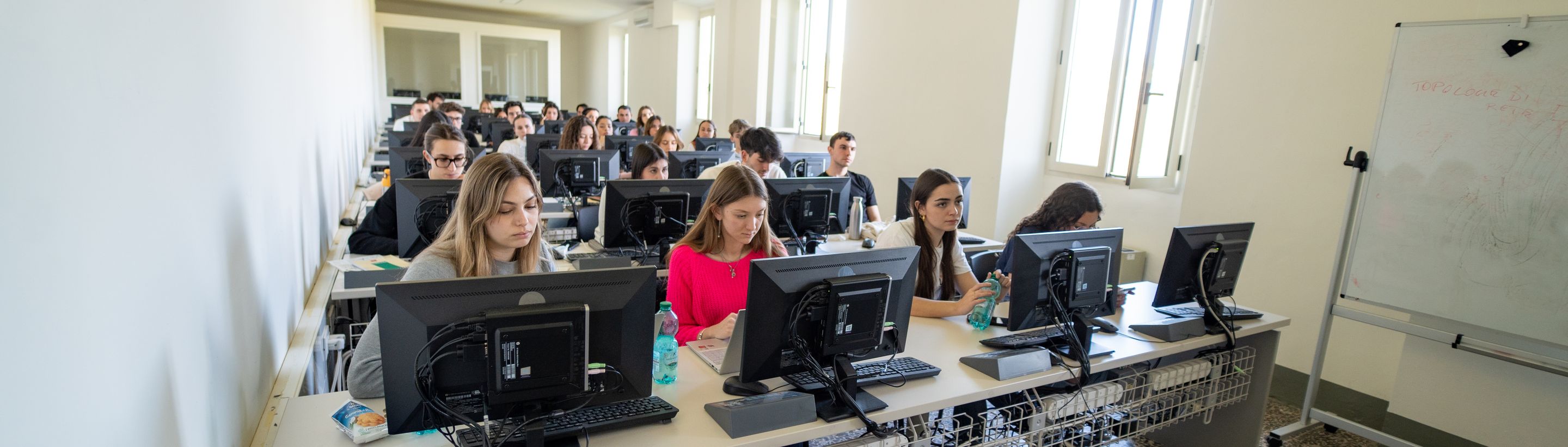 Students working at the computer workstations in the Unicollege lab