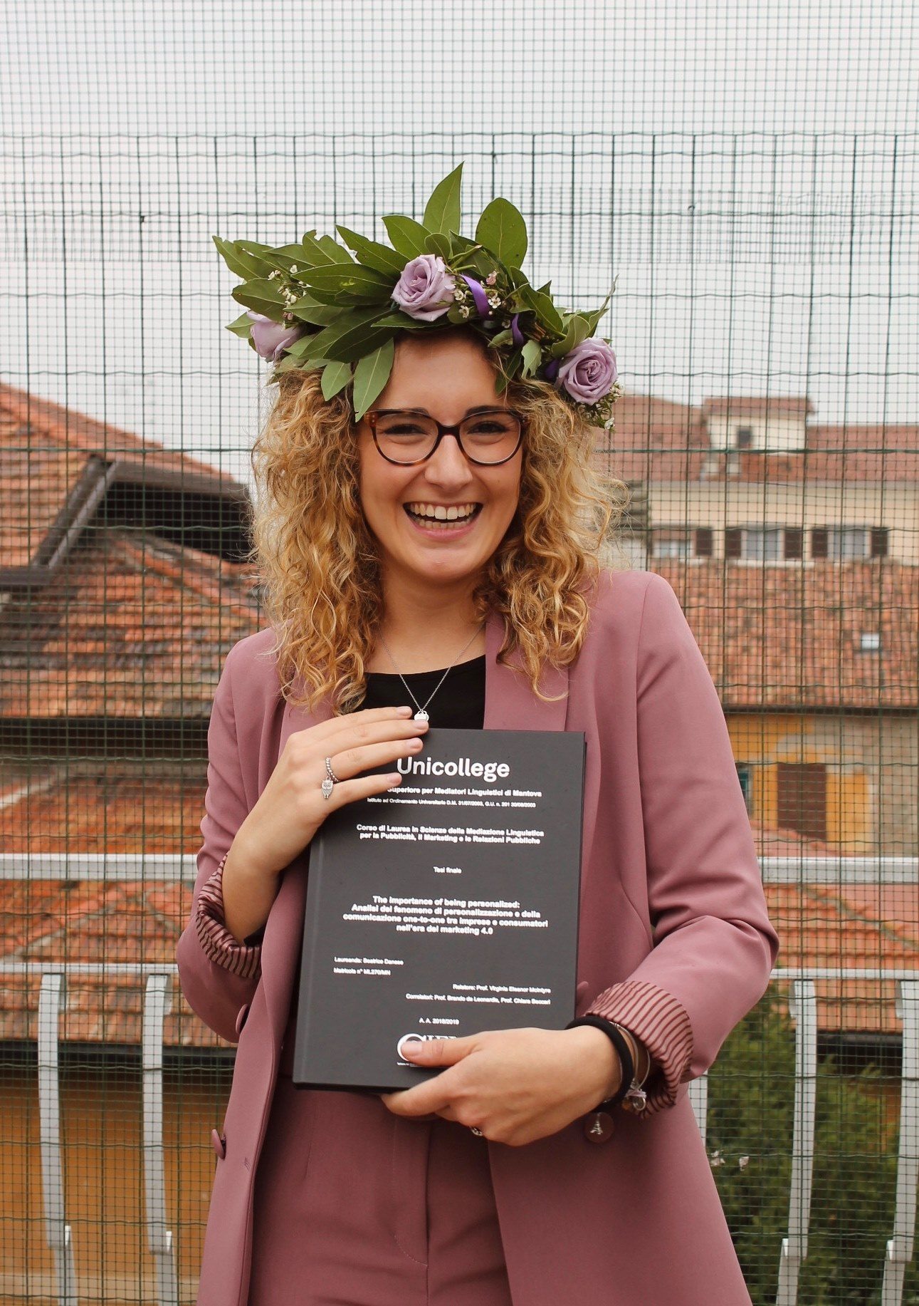 A Unicollege graduate with her floral wreath and diploma