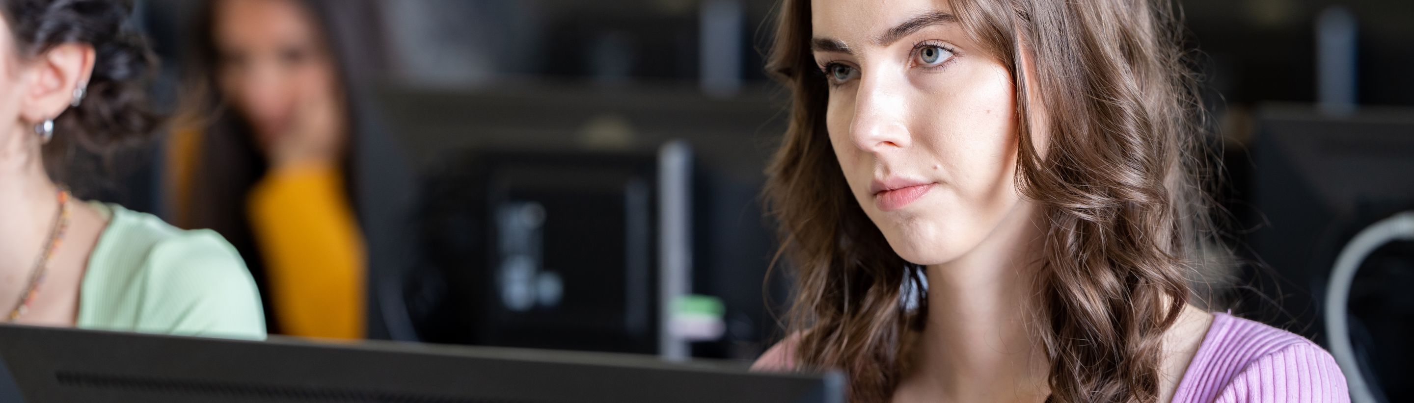 A student at her computer during a lesson in the Unicollege lab