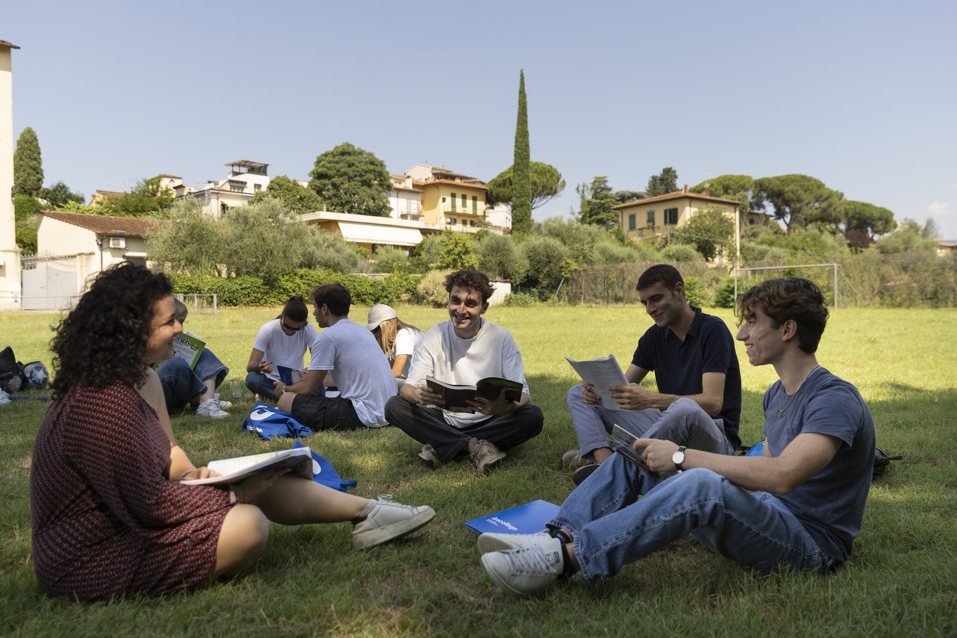 Students studying on the lawn, with the Florentine hills behind them