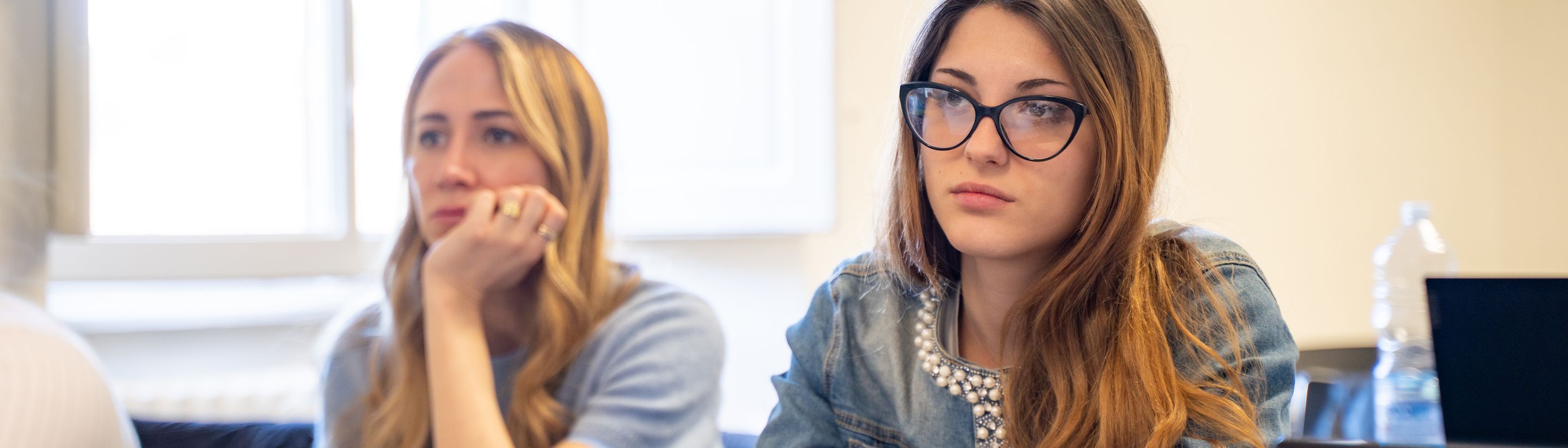 Two students listening during a lesson at Unicollege