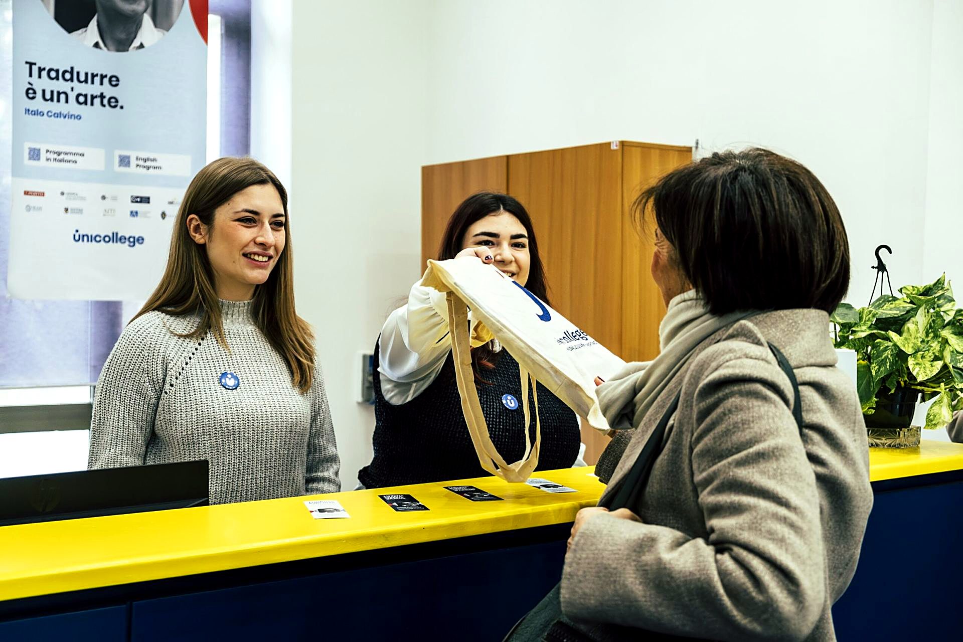 Unicollege staff welcoming a visitor at the campus front desk