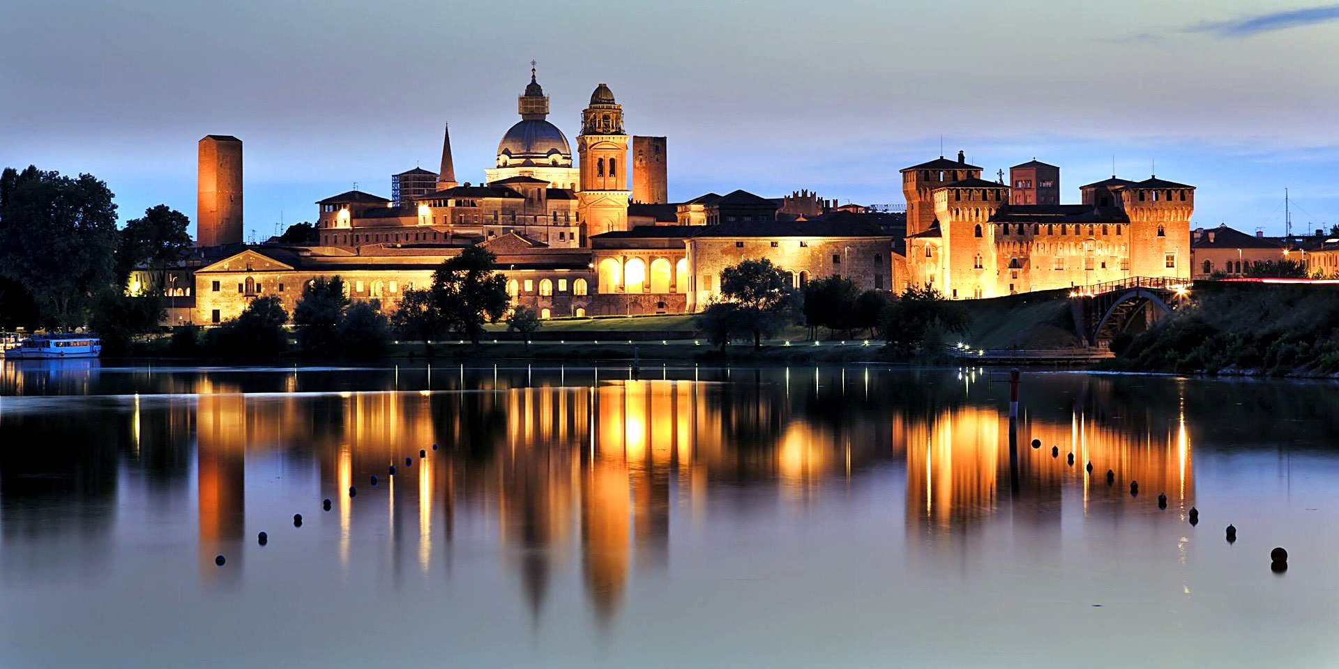 The skyline of Mantua reflected in the lake at dusk