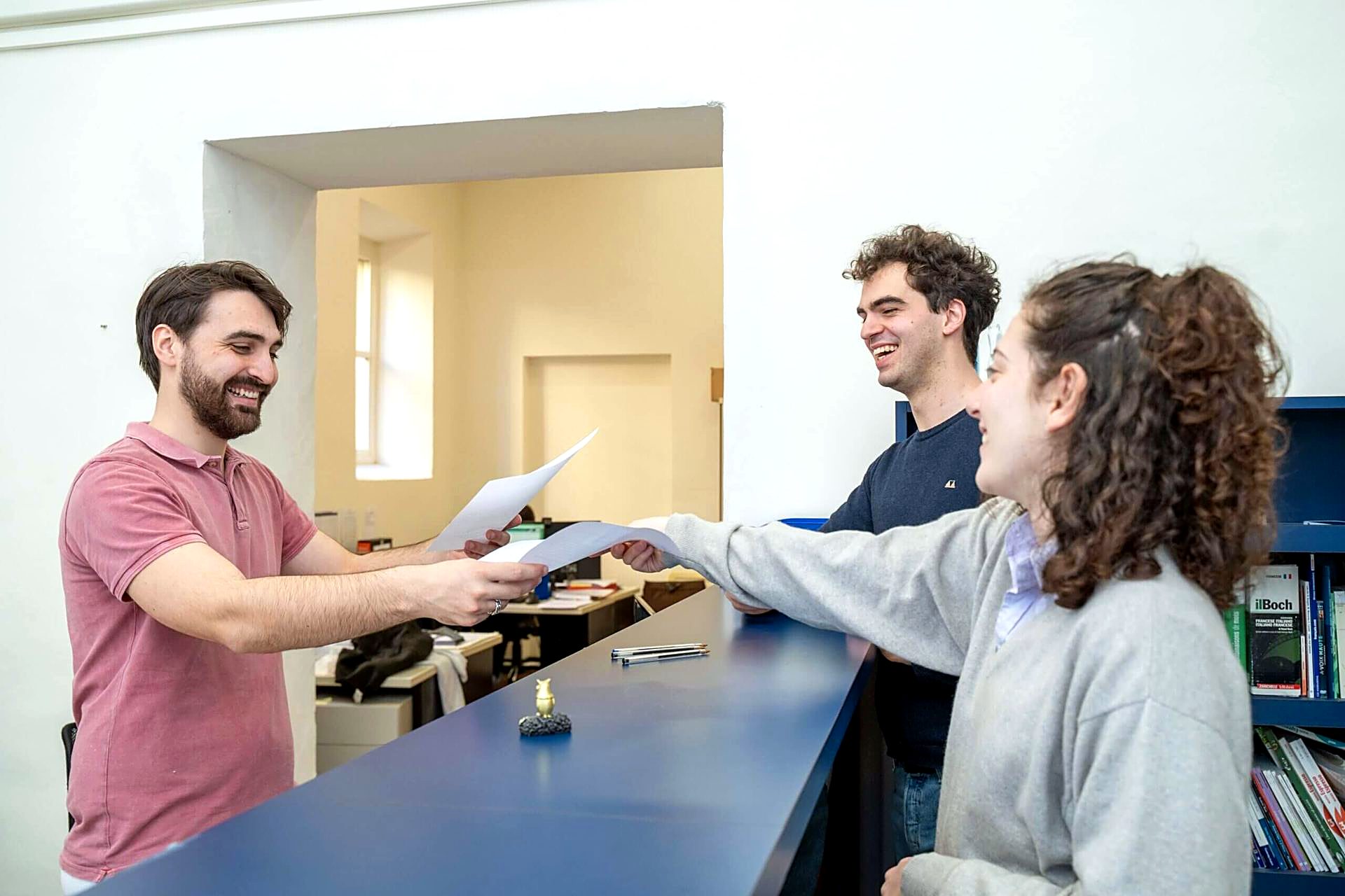 Student handing in documents at the Unicollege admissions desk