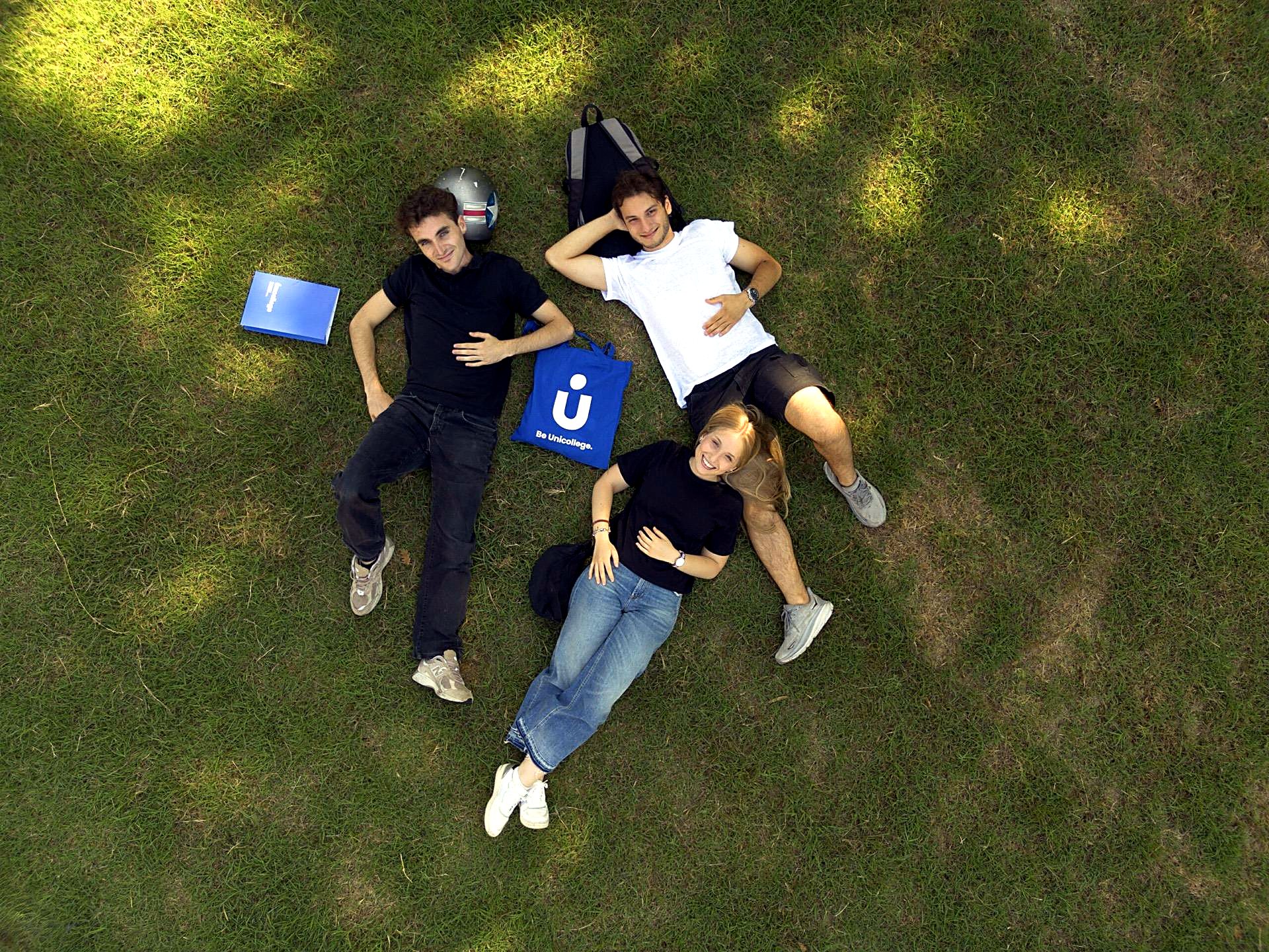 Unicollege students lying on the lawn, seen from above