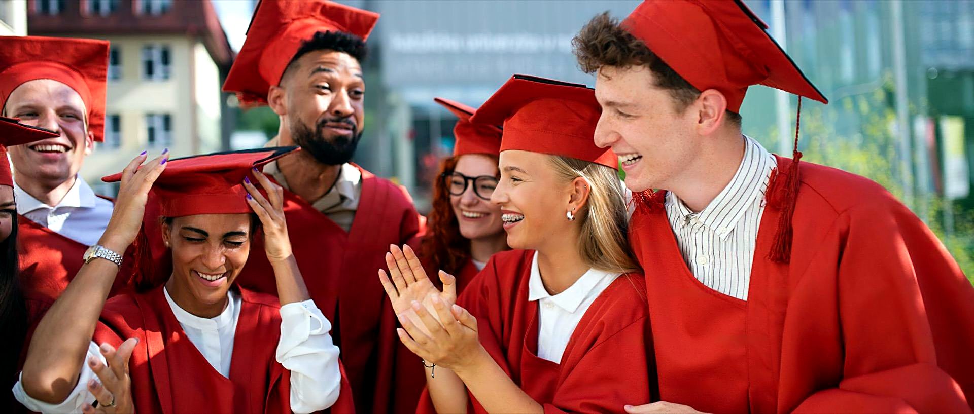 Graduates celebrating in cap and gown