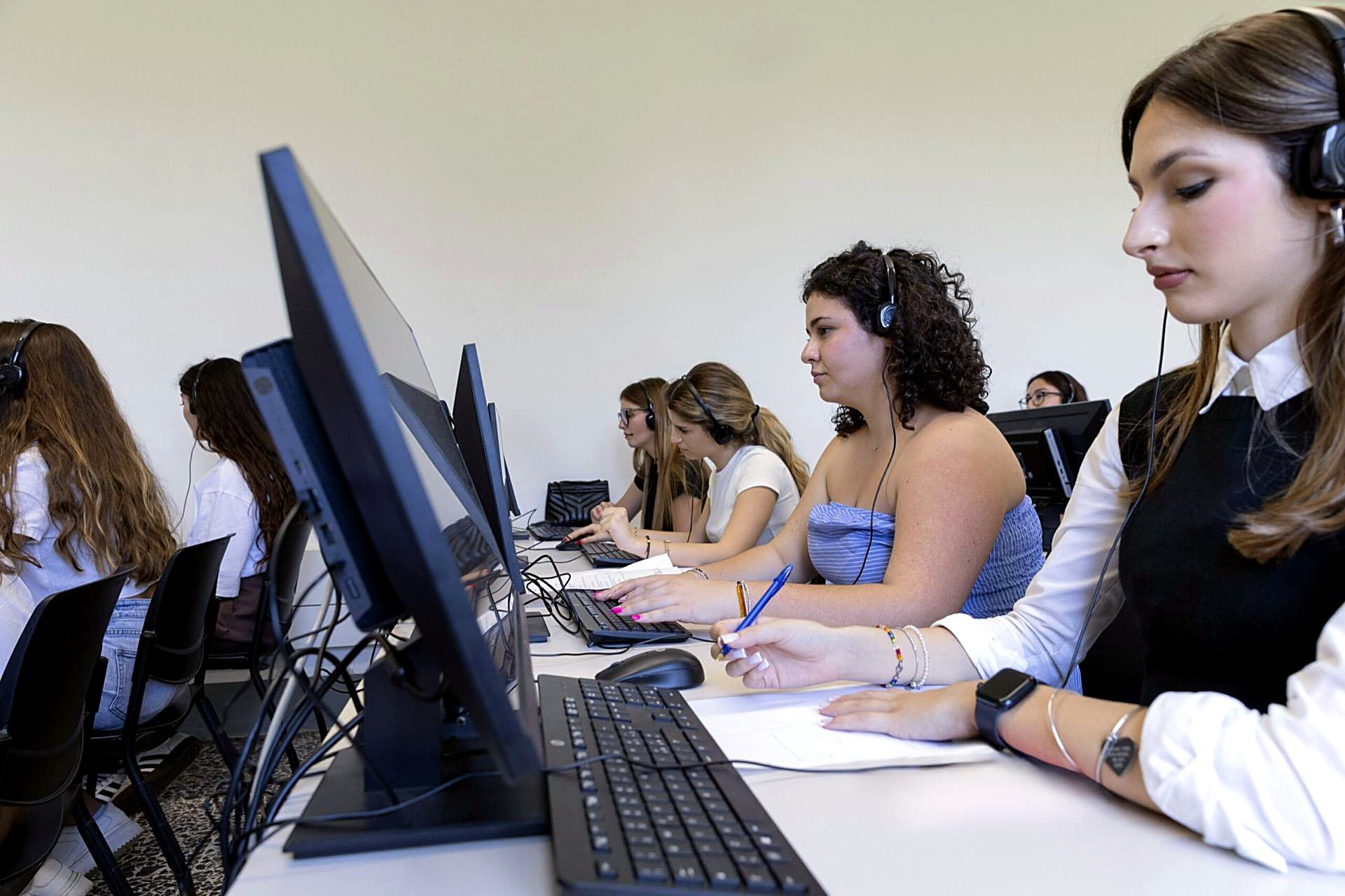 Students wearing headsets in the Unicollege language laboratory