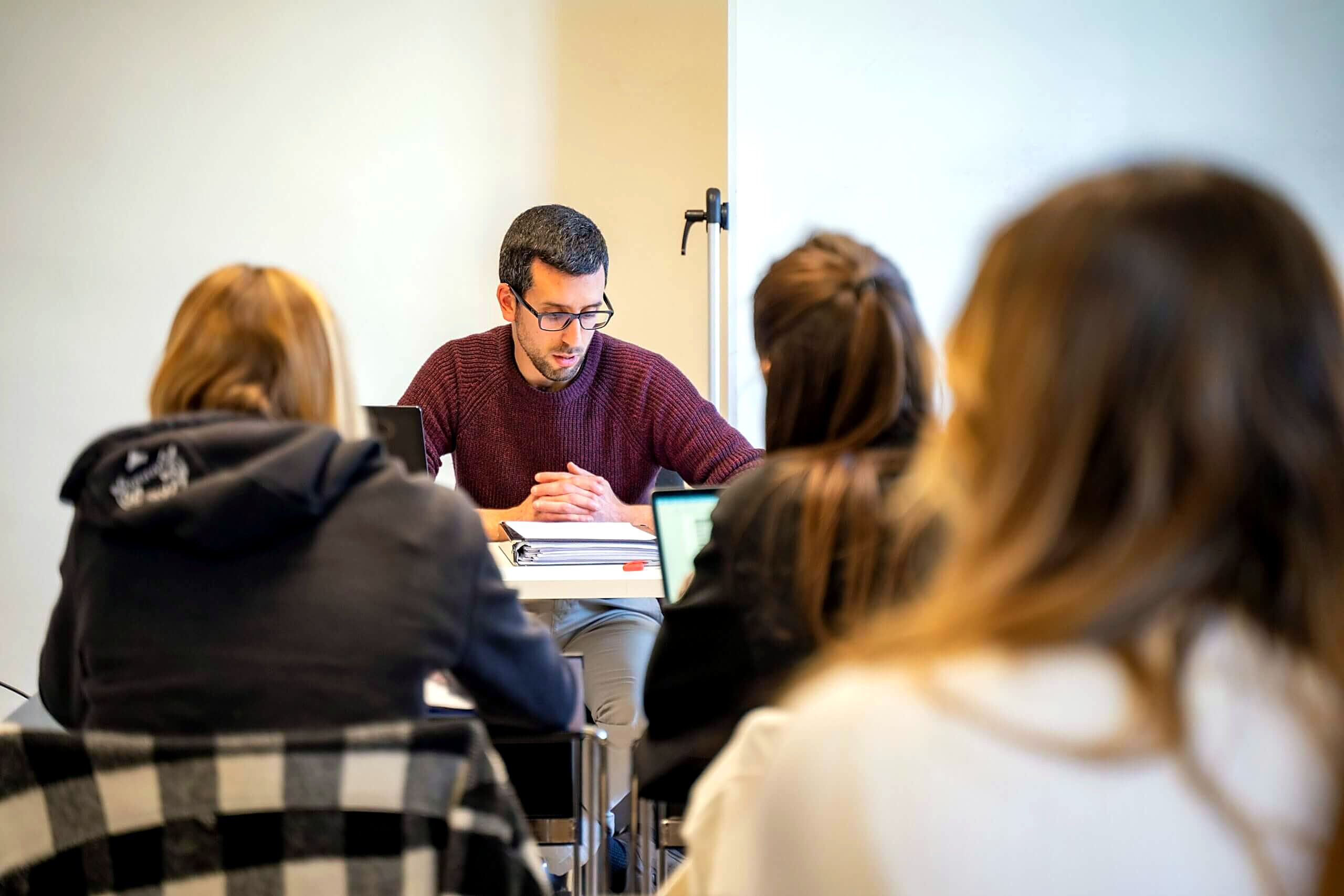 Instructor teaching a small group of students at Unicollege