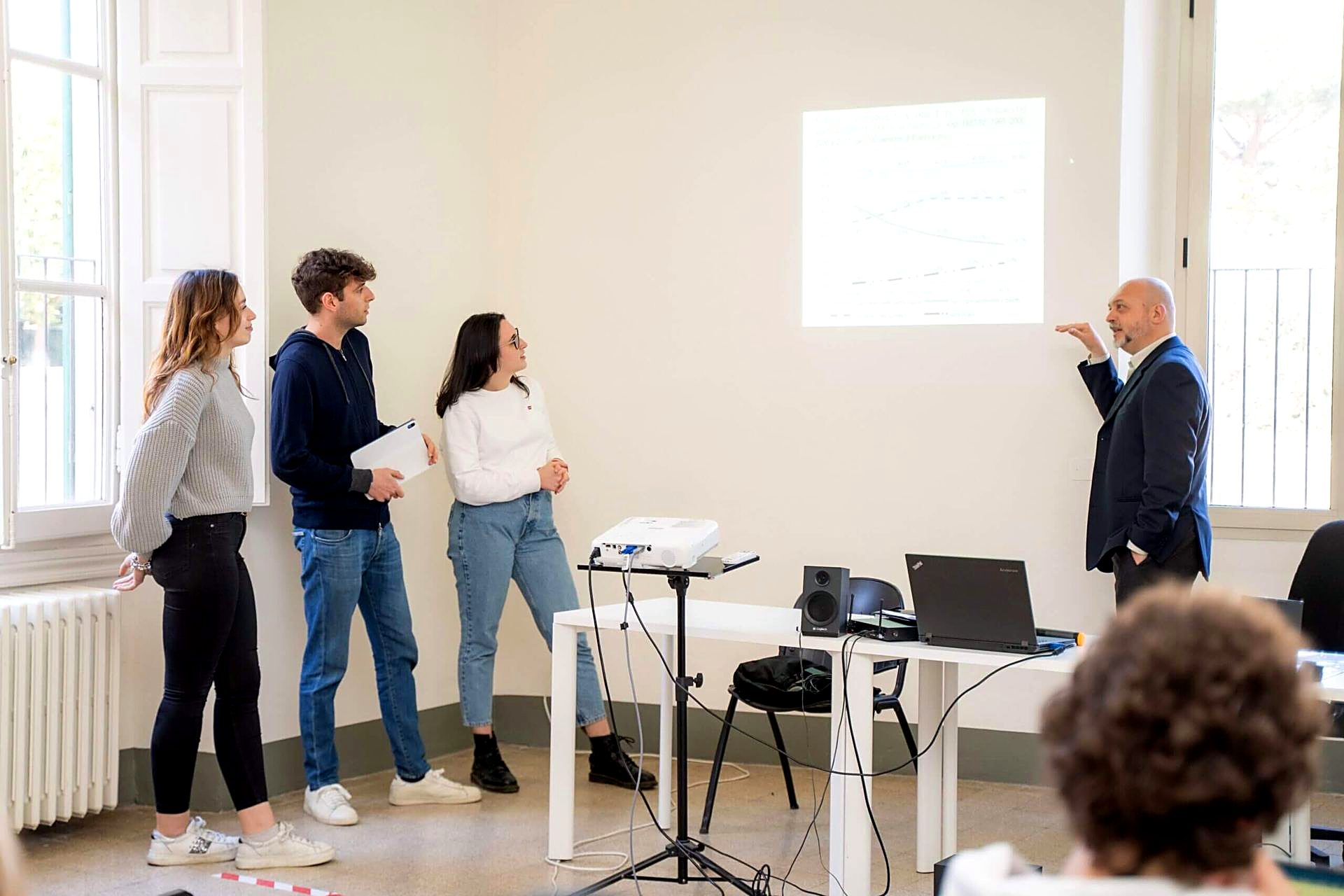 Students giving a presentation to their professor at Unicollege